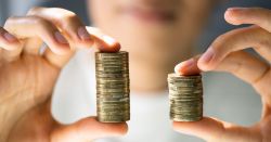 Mismatched coin stacks held by woman